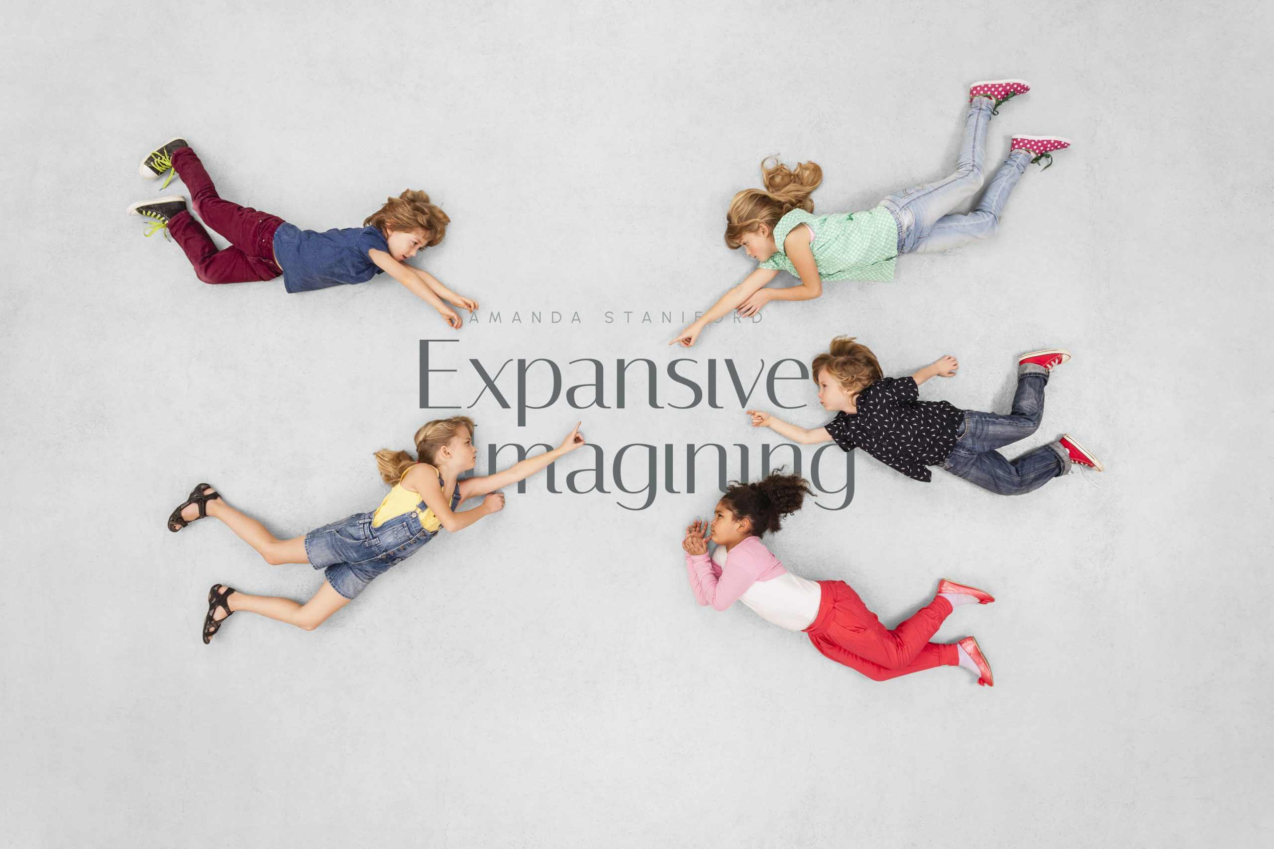 children pointing towards the Expansive Imagining logo